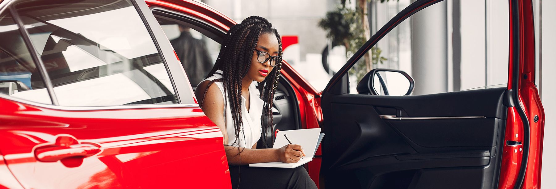 Woman in car showroom